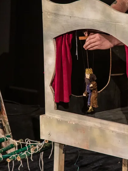 A tiny king and queen marionette are placed in their miniature theatre box during the Hungarian performance of 'Dragon and the Devil'.