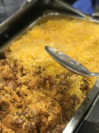 On high demand, our delicious Mutton Biryani is a crowd favorite. This close-up shot shows the perfectly cooked, flavorful rice and tender mutton, ready to be served to eager guests.