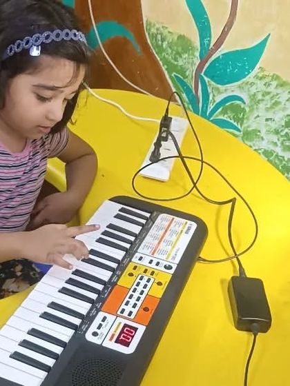 The peace and satisfaction of filling a child's life with the colors of music. This 4.5-year-old student is completely absorbed in her piano practice.
