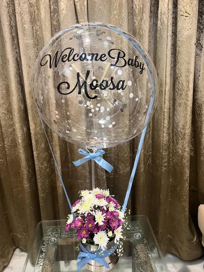Another angle of our 'Welcome Baby Moosa' arrangement, showing how the custom script on the balloon stands out against the confetti inside.