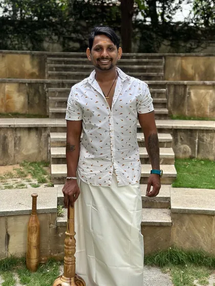 A full-length shot in my Onam attire with the Gada. It shows the connection between my cultural heritage and fitness philosophy.