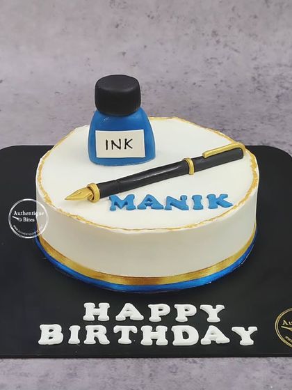 A simple and elegant cake for a writer or pen enthusiast, featuring a classic fountain pen and an ink bottle.