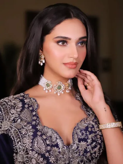 Another close-up, focusing on the bride's flawless makeup and the elegant jewellery pairing.
