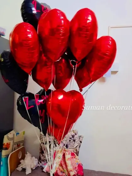 A simple bouquet of red and black heart-shaped foil balloons. This is a classic choice for Valentine's Day, anniversaries, or to show someone you care.