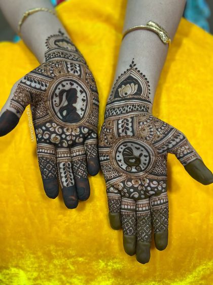 This godh bharai mehendi features a silhouette of a pregnant mother on one hand and a baby in a cradle on the other. It's a beautiful and artistic way to capture the essence of this special time.