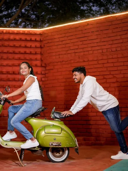 A playful moment with a vintage green scooter. Props are a great way to add fun and personality to your pre-wedding photos.