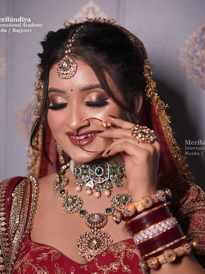 A happy, smiling bride is the best canvas. This look features a classic red lehenga with soft, shimmering eye makeup for a timeless appeal.