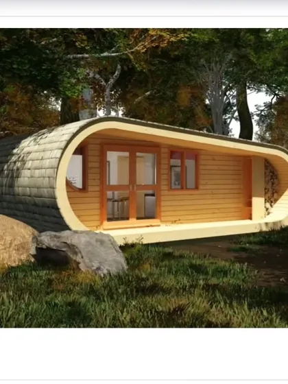 This unique "log-like" cabin design shows our creative potential. The exterior is a loop of shingles, while the interior is a cozy, fully-equipped living space with a kitchen, bed, and seating area.