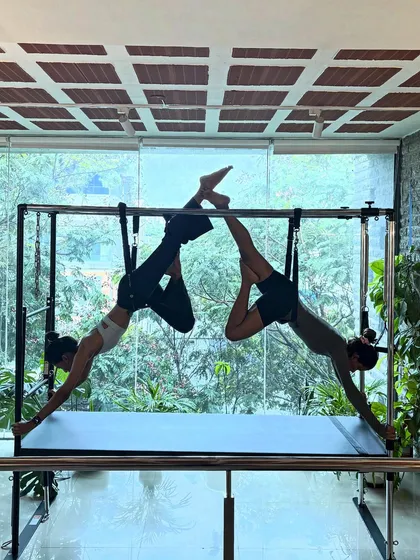 Togetherness in movement. This synchronized partner pose on the Cadillac showcases trust, balance, and shared strength.