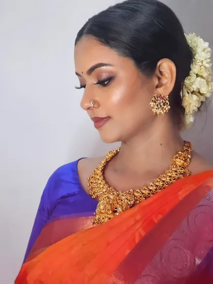 A close-up of my self-makeup look, showing the detailed eye makeup and the beautiful jewelry.