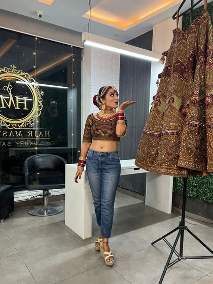 A fun, modern twist with the bride in her full bridal makeup and hair, but wearing jeans before changing into her lehenga. It shows the versatility and confidence my clients feel.