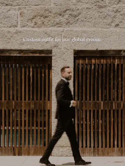 Style in motion. A groom confidently walks in his custom-made black tuxedo, a garment designed not just for appearance but for comfort and movement, ensuring elegance from the ceremony to the celebration.