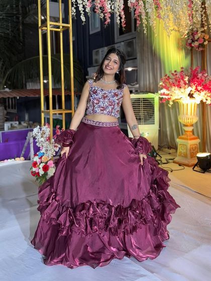 The full view of this ruffled maroon lehenga shows off its volume and texture. It’s a fantastic rental choice for someone who wants a unique and fashion-forward look for a wedding reception.