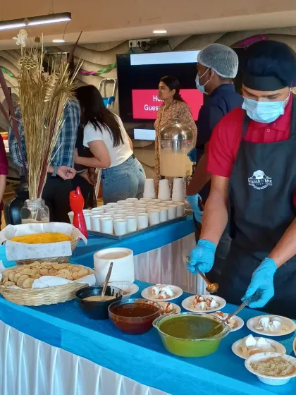 Our live chaat counter is always a hit at corporate family days and celebrations. Here, our chef prepares plates of dahi puri for guests, adding a fun and flavorful element to the event.