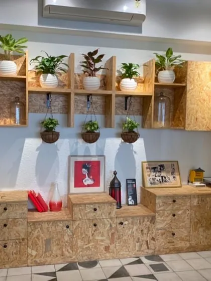Your home office should be a place of inspiration. I designed this creative workspace using a combination of potted plants on modular shelving and hanging planters to add layers of green, making the room feel more dynamic and peaceful.