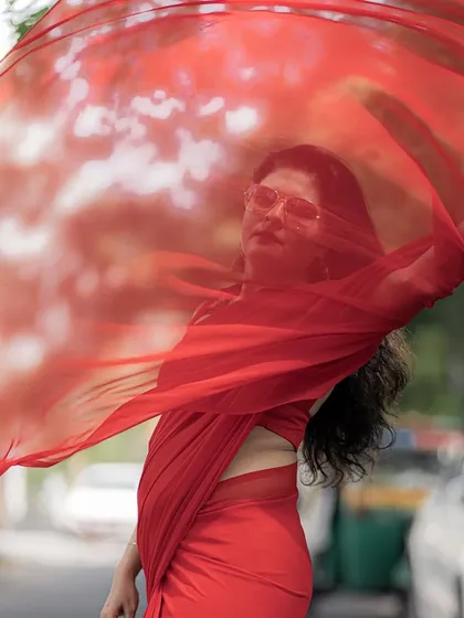 Style should be dynamic and expressive. I love playing with simple fabrics like this red georgette saree, using movement and a bold color to create a powerful and memorable fashion statement.