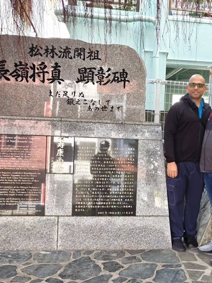 Paying respects at the monument of Shoshin Nagamine, a legendary karate master, in Tomari, Okinawa. Understanding history is key to practicing the art.