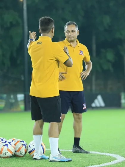 Two of our coaches discussing strategy during a training session.