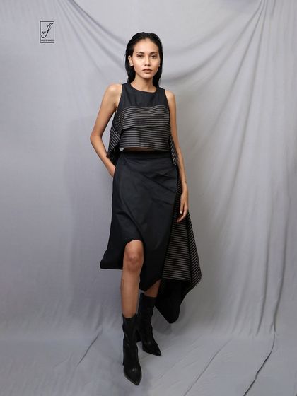 A relaxed yet strong standing pose that provides a clear, full view of the avant-garde outfit.