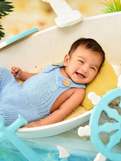 A big, happy smile from our littlest sailor. Even at this young age, we can capture moments of pure joy and personality.