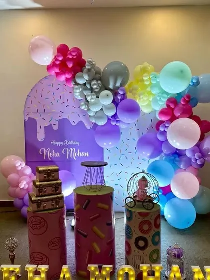 Another angle of the donut and sweets themed party, showing the fun and colorful balloon arrangement.
