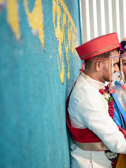 A sweet and intimate embrace, set against a colorful and traditional backdrop.