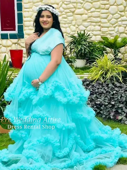 This light aqua ruffled gown is perfect for a serene and dreamy garden photoshoot. The cascading layers of tulle create a soft, cloud-like effect, adding a touch of whimsy to your maternity photos.