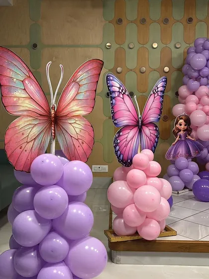 A close-up of the large, detailed butterfly cutouts used as props for the party.