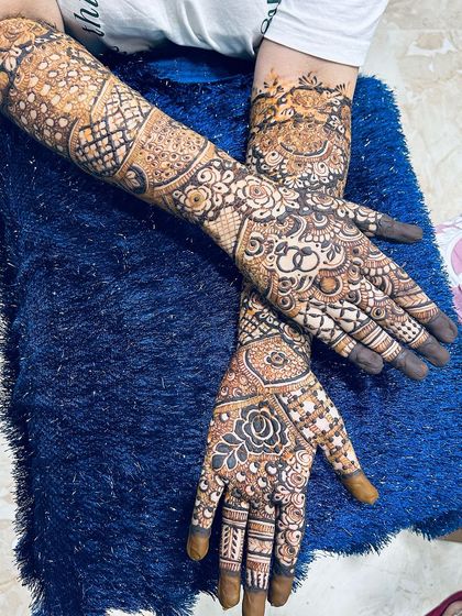 A crossed-hands pose showing the beautiful flow of the design on the back of the arms.