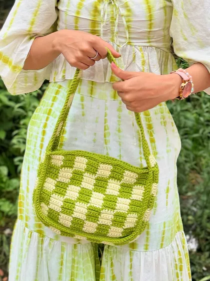 A close-up of the handcrafted details of our checkered crochet bag, showing the texture and quality of the yarn work.