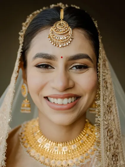 The joy on a bride's face is my biggest reward. This happy South Indian bride is glowing with a minimal makeup look that complements her traditional gold jewelry and silk saree, proving that sometimes less is truly more.