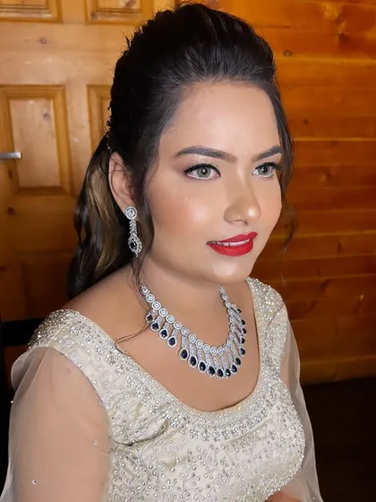 A beautiful smile from my client, all set for her Sangeet. The combination of glittery eyes and a bold red lip is a classic choice for an evening of celebration and dancing.