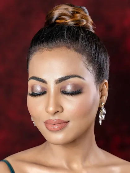A close-up profile view of the soft glam eye makeup. This angle showcases the flawless blending, lash application, and the subtle glow on the high points of the face.