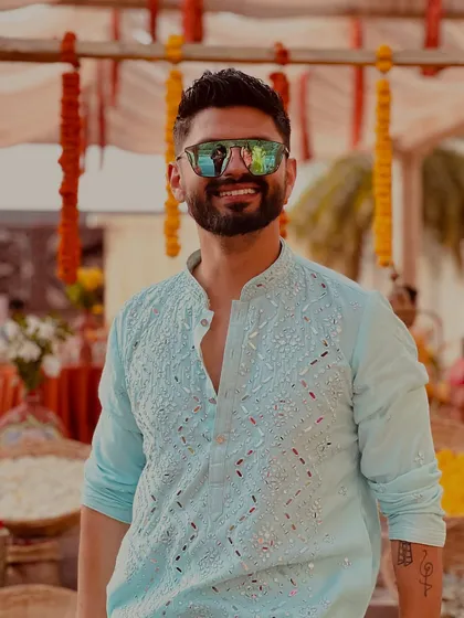A close-up of the light blue kurta, showing off the mirror work and my happy smile.