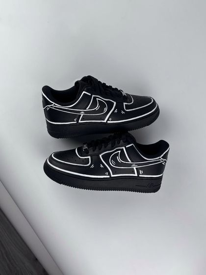 A top-down view of the black cartoon custom sneakers.