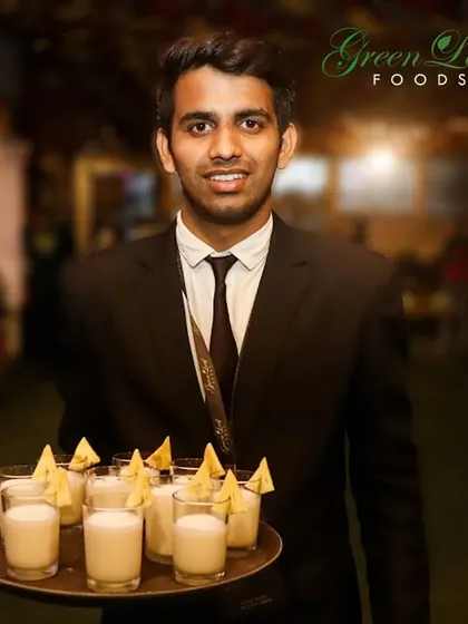 Our professional staff ensures that every guest is well taken care of. Here, a server offers a tray of welcome drinks, showcasing our commitment to warm and attentive hospitality from the moment guests arrive.