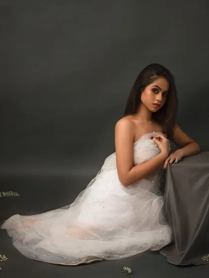 Wrapped in light and the whispers of pearls. This fine art portrait in a delicate white dress has a soft, ethereal quality that is both innocent and captivating.