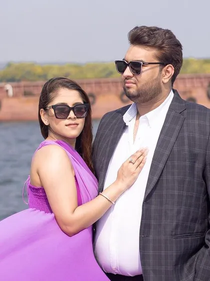 A classic couple portrait on a yacht in Goa, capturing their stylish look against the open water.