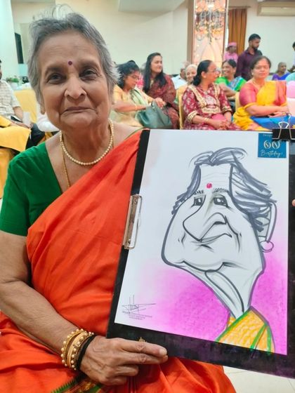 An elderly guest with her caricature. It's heartwarming to see people of all ages enjoy my art.