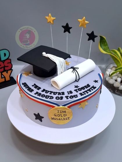 A graduation cake for an IIM Gold Medalist, featuring a graduation cap, diploma, and a gold medal.