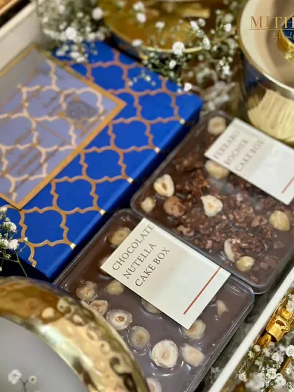 A peek inside a gender reveal hamper, showcasing my Chocolate Nutella and Ferrero Rocher cake boxes. The royal blue packaging adds to the suspense and excitement of the special moment.