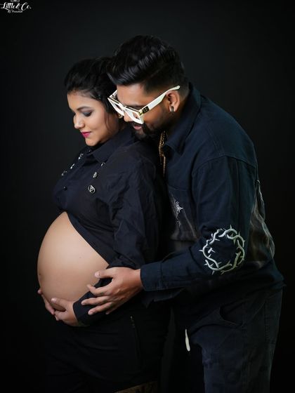 A quiet, shared moment between the couple as they both look down at the baby bump. This image is full of love, tenderness, and anticipation.