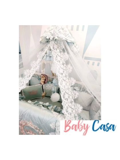 A detail shot of the mint green lace bedding. This view shows the delicate, high-quality lace used to create a dreamy and luxurious feel for the baby's crib.