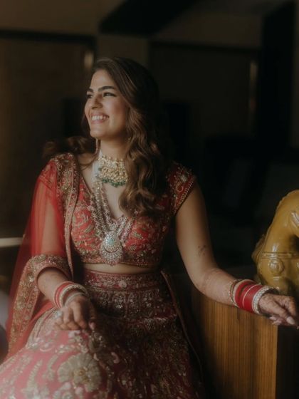 A radiant bride on her wedding day. Her mehendi, though subtle in this shot, is an essential part of her overall look, complementing her stunning lehenga and jewelry.
