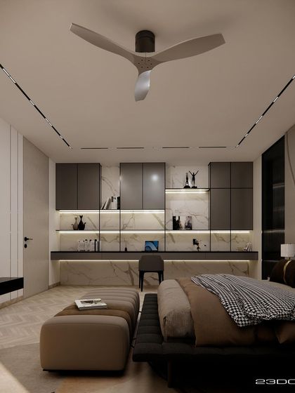 In this bedroom from our Meraki project, a built-in study nook with marble backing and integrated lighting provides a functional and stylish workspace. The design uses a palette of warm neutrals and dark wood for a contemporary, intellectual feel.