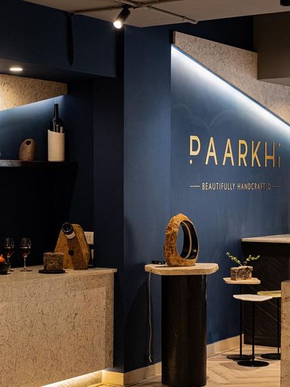 This image captures the sublime ambiance of the boutique, where the sleek lines of the bar and reception counters harmonise with the natural beauty of the stone materials. The lighting design was crucial in creating this serene and opulent feel.