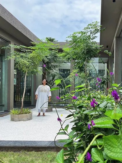 My principal designer, Shruti, enjoying the tranquility of the office courtyard. The space is designed to be an immersive green retreat, with purple flowering creepers adding a splash of color.