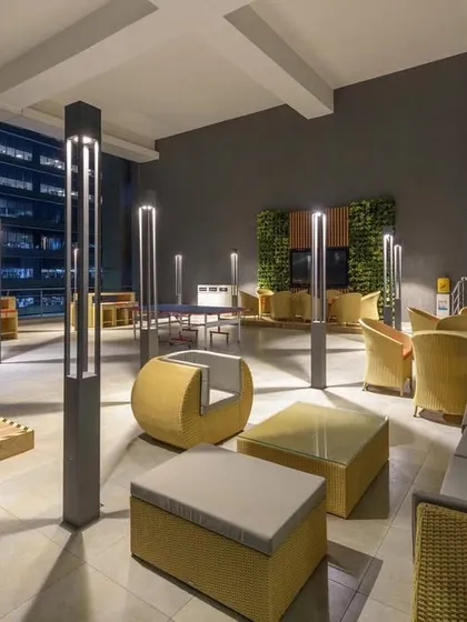 Terraces have great potential to become collaboration or coffee spaces. We designed this outdoor lounge with modern furniture and lighting for evening use.