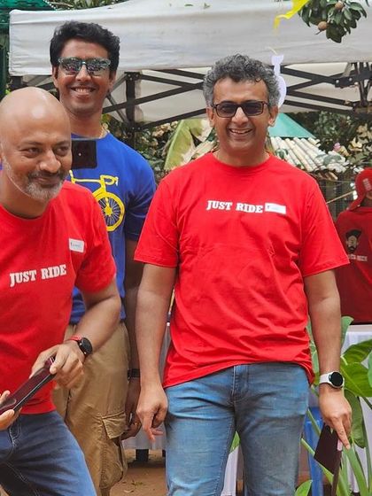 Our Spokes Men volunteers enjoying the Garage Sale atmosphere in their bright red 'Just Ride' T-shirts.