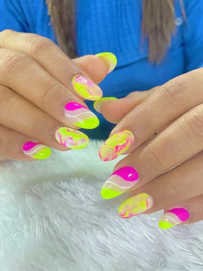 Vacation nails done right. This vibrant set features a neon yellow and pink marble design, perfect for making a statement on your next trip.